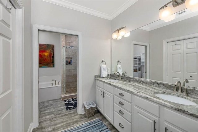 bathroom with vanity, hardwood / wood-style floors, ornamental molding, and independent shower and bath