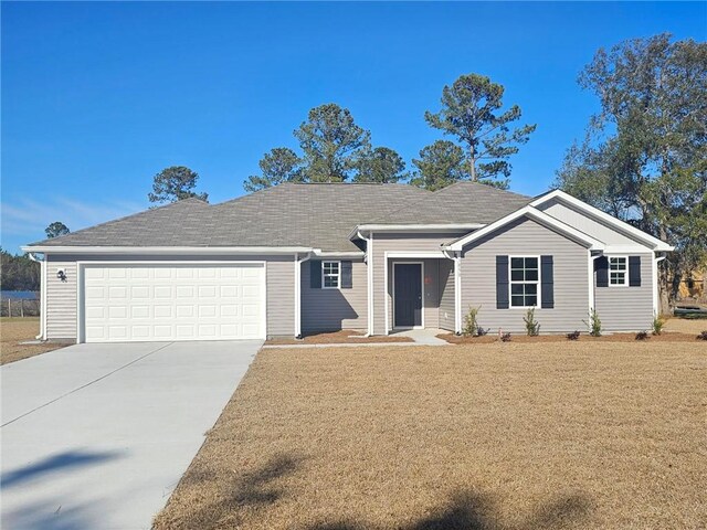 ranch-style home with a yard and a garage