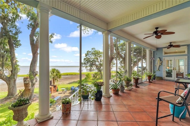 sunroom with a water view and ornate columns