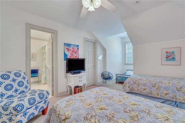 bedroom featuring ceiling fan, light colored carpet, lofted ceiling, and ensuite bathroom