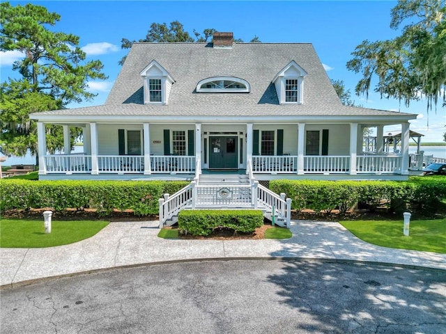 farmhouse inspired home featuring covered porch