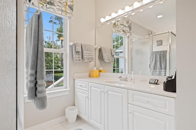 bathroom with tile patterned floors, plenty of natural light, and a shower with shower door