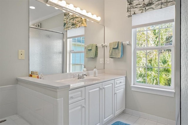 bathroom featuring vanity, tile patterned floors, walk in shower, and crown molding