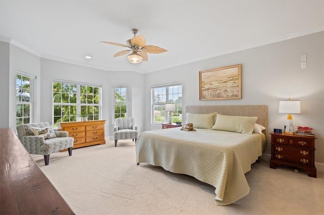 bedroom with ceiling fan, ornamental molding, and carpet floors