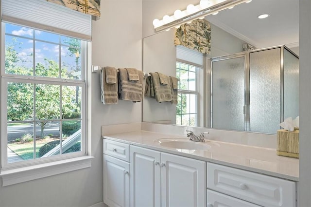 bathroom featuring vanity, walk in shower, and crown molding