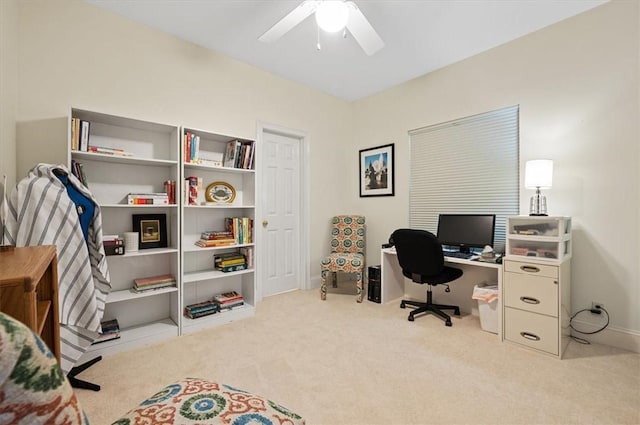 carpeted office space with ceiling fan