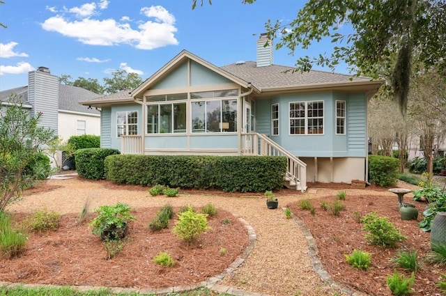 23 W Lake Dr, Saint Simons Island, GA 31522 - rear view of property featuring a sunroom, stairway, and a chimney