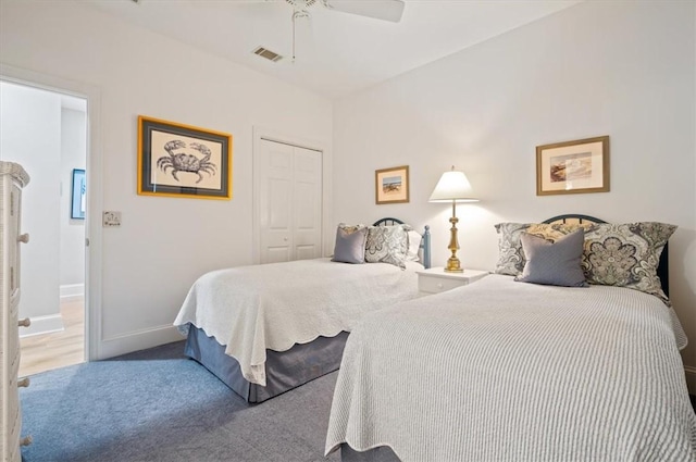 carpeted bedroom featuring a closet and ceiling fan