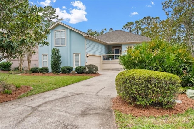 23 W Lake Dr, Saint Simons Island, GA 31522 - view of front of house featuring a garage, driveway, stucco siding, a front yard, and a chimney