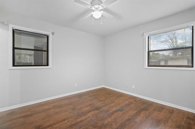 unfurnished room featuring ceiling fan and dark wood-type flooring