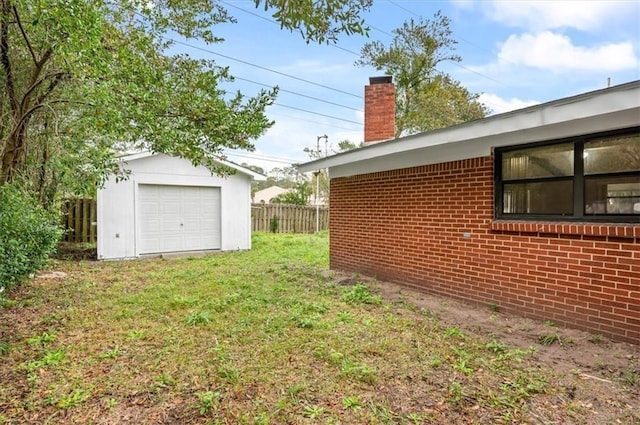 view of yard featuring an outbuilding and a garage