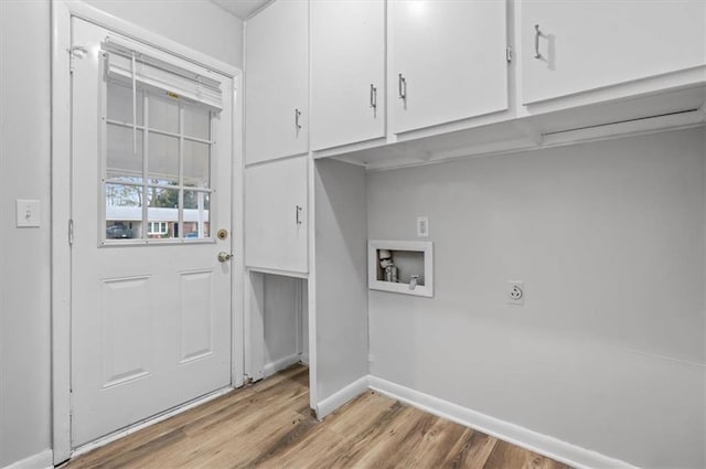 clothes washing area with hookup for an electric dryer, cabinets, light wood-type flooring, and hookup for a washing machine