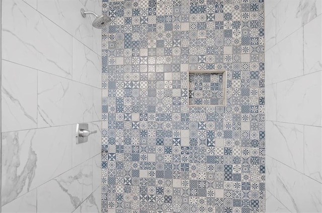 bathroom with a tile shower