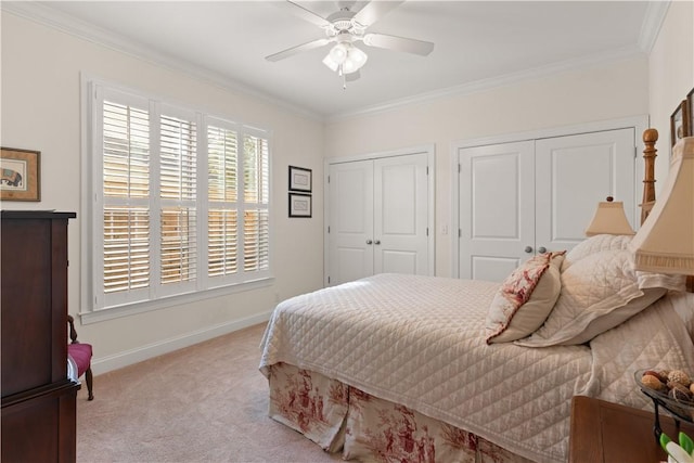 1045 Sinclair Pointe Pt, Saint Simons Island, GA 31522 - bedroom featuring two closets, crown molding, light carpet, and ceiling fan