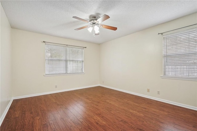 unfurnished room with a textured ceiling, dark hardwood / wood-style flooring, and ceiling fan