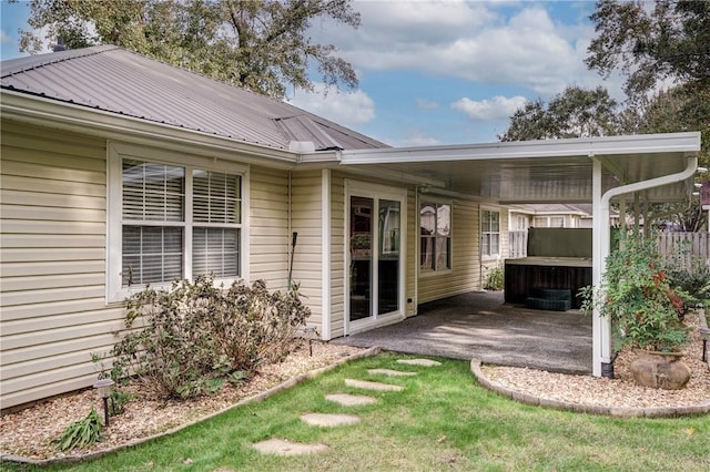 back of house featuring a patio and a hot tub