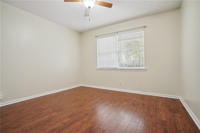 empty room with ceiling fan, wood-type flooring, and a textured ceiling