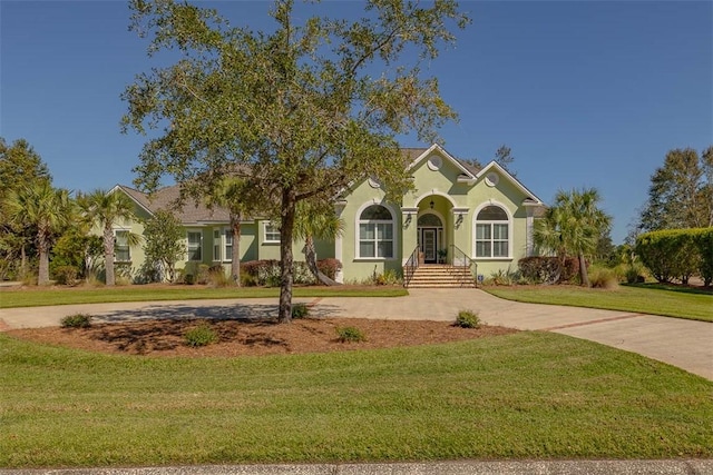 mediterranean / spanish home with a front yard