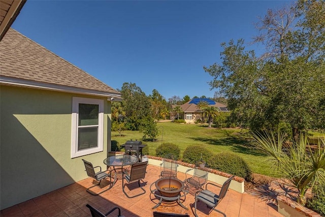 view of patio / terrace with an outdoor fire pit