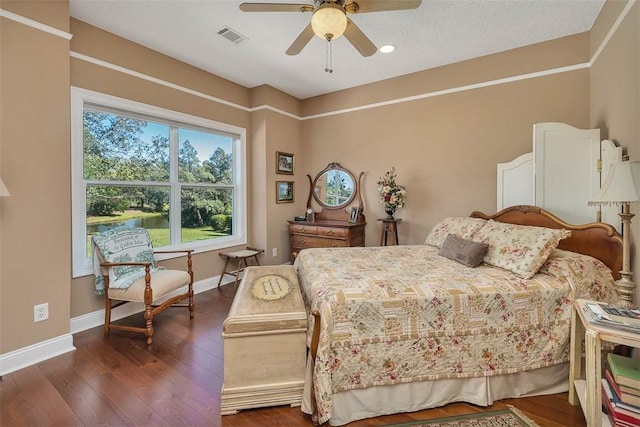 bedroom featuring ceiling fan and dark hardwood / wood-style flooring