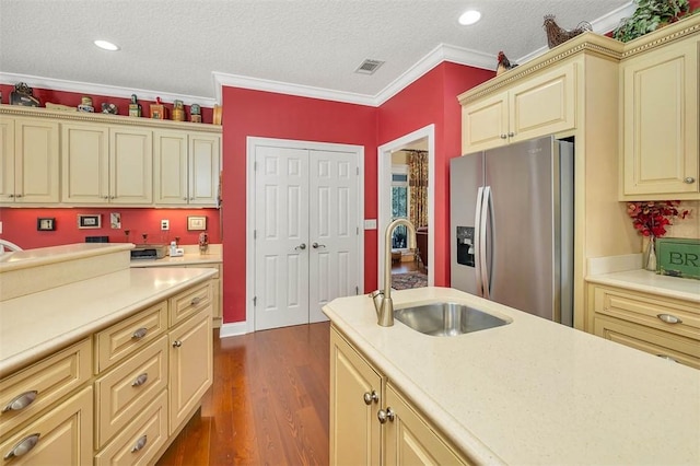 kitchen with stainless steel fridge, dark hardwood / wood-style flooring, ornamental molding, a textured ceiling, and sink