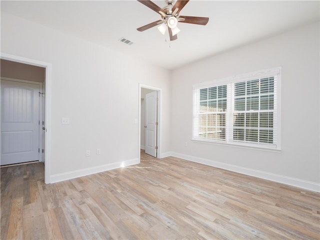 unfurnished room with ceiling fan and light wood-type flooring