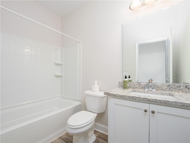 full bathroom with bathing tub / shower combination, vanity, hardwood / wood-style flooring, and toilet