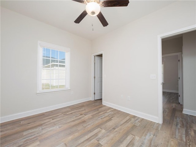 unfurnished room with light wood-type flooring and ceiling fan