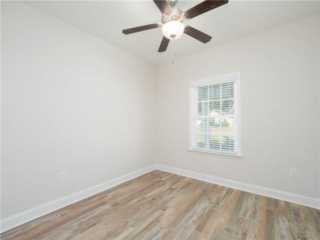 empty room with ceiling fan and light wood-type flooring