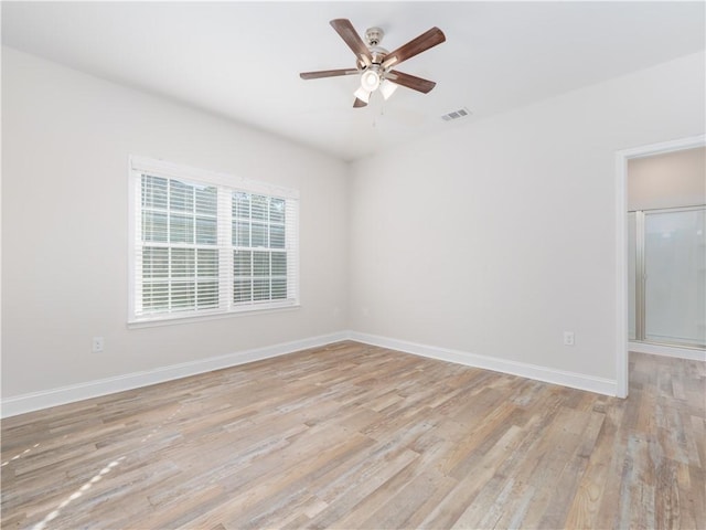 unfurnished room with ceiling fan and light wood-type flooring