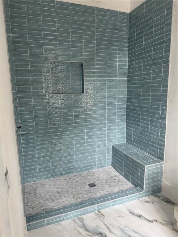 full bath featuring tiled shower