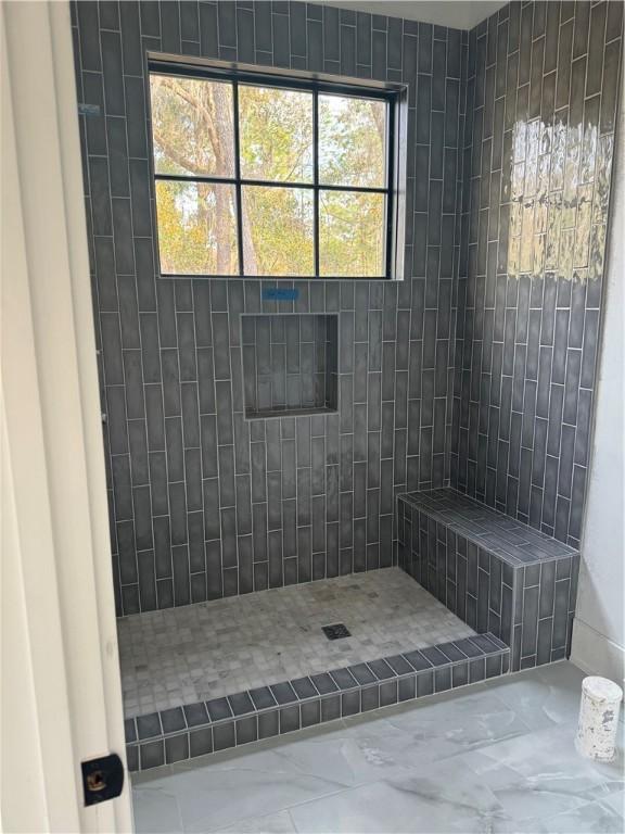 full bath with a tile shower