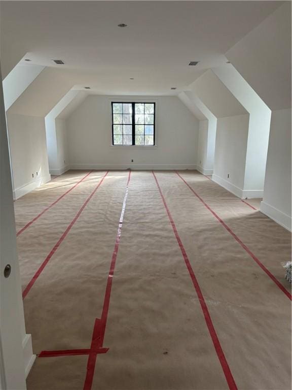 bonus room featuring vaulted ceiling and visible vents