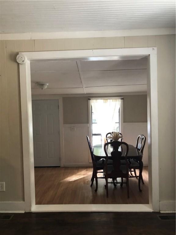 dining space featuring dark wood-type flooring