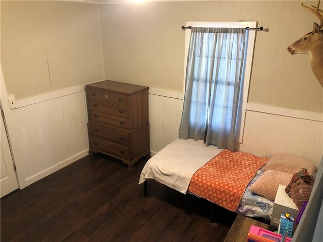 bedroom with dark hardwood / wood-style flooring