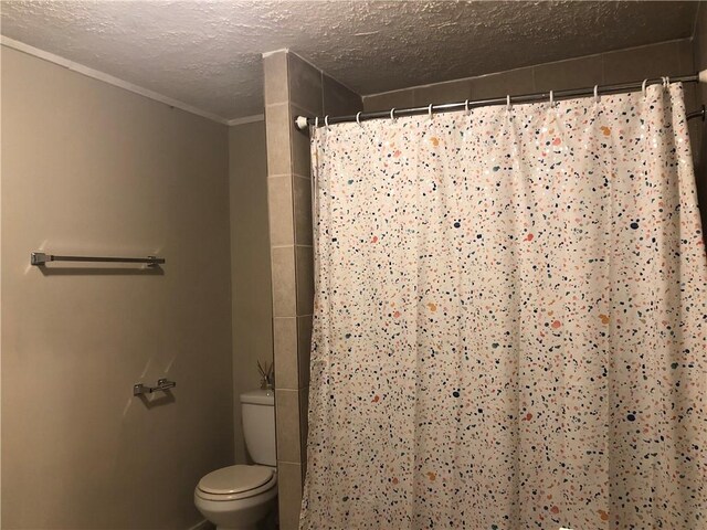 bathroom with toilet, a textured ceiling, and walk in shower