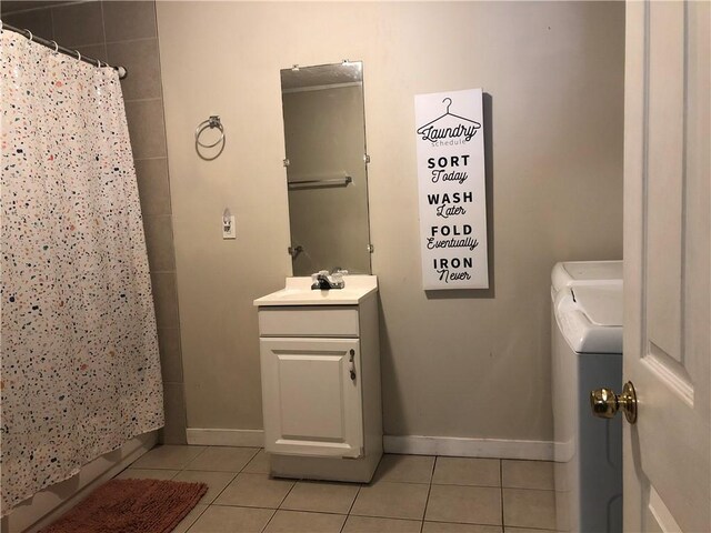 bathroom with tile patterned floors, vanity, curtained shower, and washing machine and clothes dryer