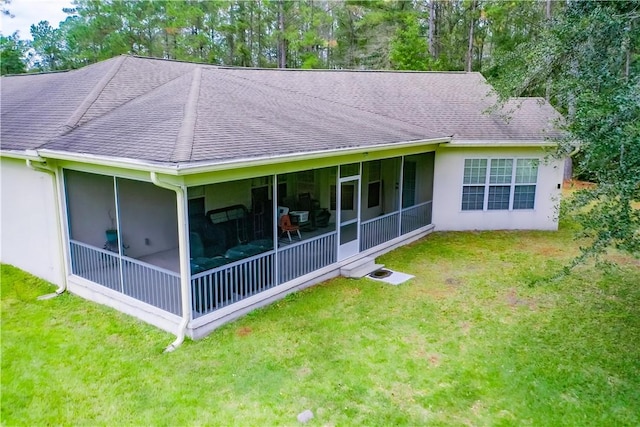 rear view of property featuring a sunroom and a yard