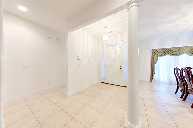 tiled entryway featuring decorative columns