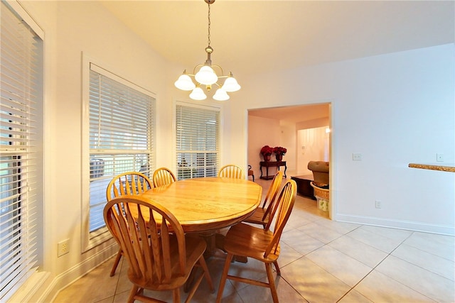 dining room featuring light tile patterned floors and a chandelier