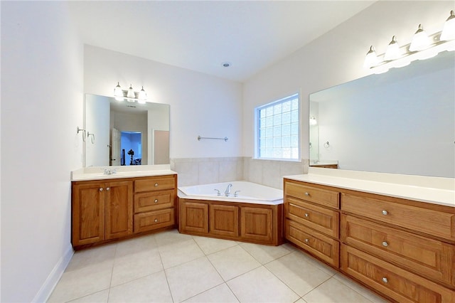 bathroom featuring a bathing tub, tile patterned flooring, and vanity