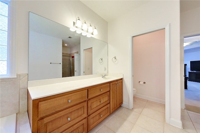 bathroom with tile patterned floors, vanity, toilet, and an enclosed shower