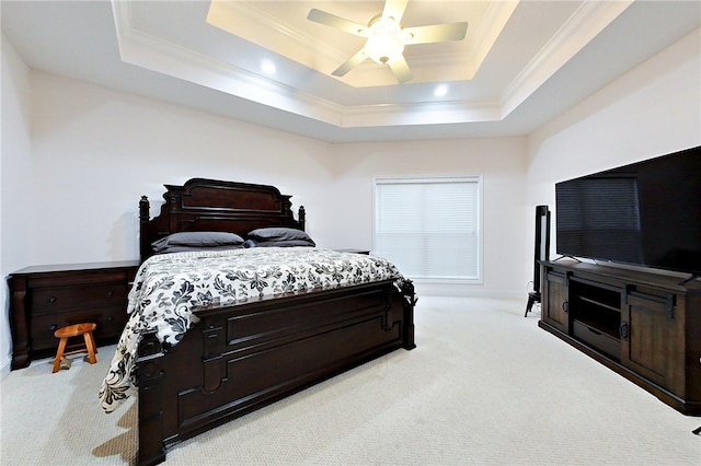 carpeted bedroom featuring a raised ceiling, ceiling fan, and ornamental molding