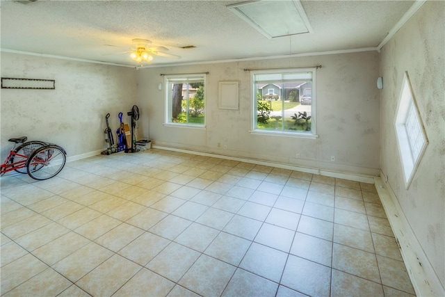 tiled empty room featuring a textured ceiling, ceiling fan, and crown molding