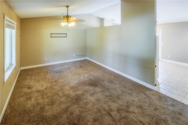 unfurnished room featuring light colored carpet, ceiling fan, and lofted ceiling