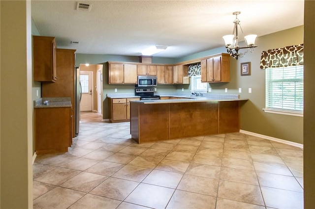 1709 Suwanne Dr, Waycross, GA 31501 - kitchen with stainless steel appliances, a peninsula, and healthy amount of natural light