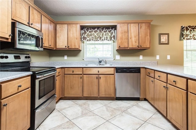 1709 Suwanne Dr, Waycross, GA 31501 - kitchen featuring stainless steel appliances, a sink, light countertops, and brown cabinets