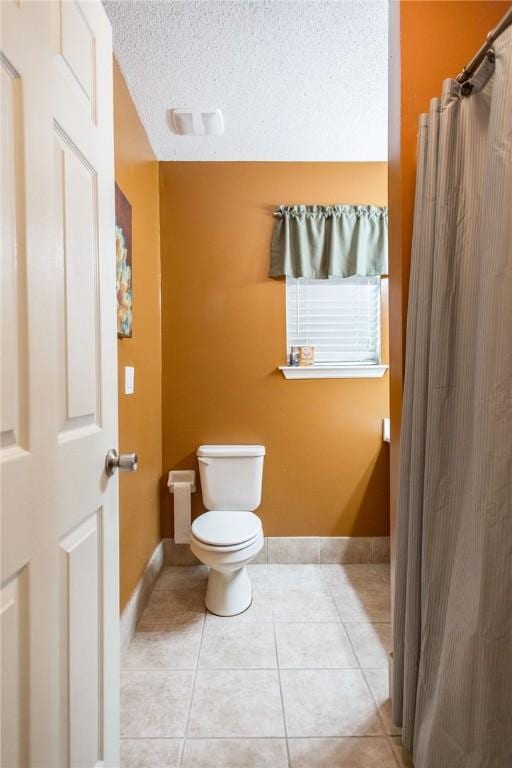 1709 Suwanne Dr, Waycross, GA 31501 - full bathroom with toilet, baseboards, tile patterned floors, a shower with curtain, and a textured ceiling
