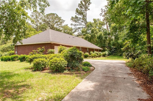 1709 Suwanne Dr, Waycross, GA 31501 - view of home's exterior featuring concrete driveway, a lawn, and brick siding