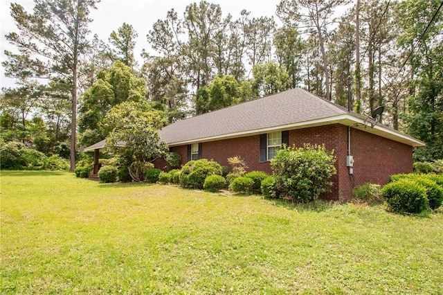 1709 Suwanne Dr, Waycross, GA 31501 - view of side of home with a lawn, brick siding, and view of scattered trees